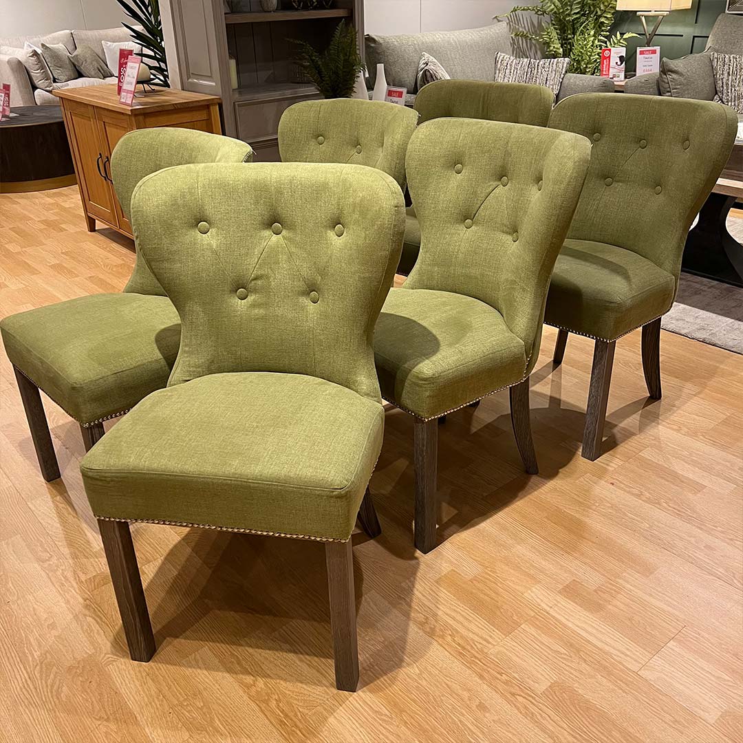 Green buttoned dining chairs