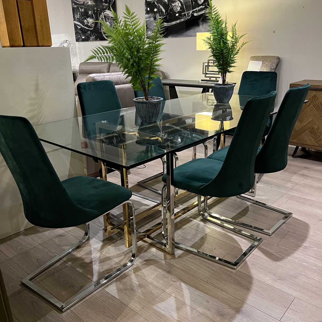 Glass and chrome table with green chairs