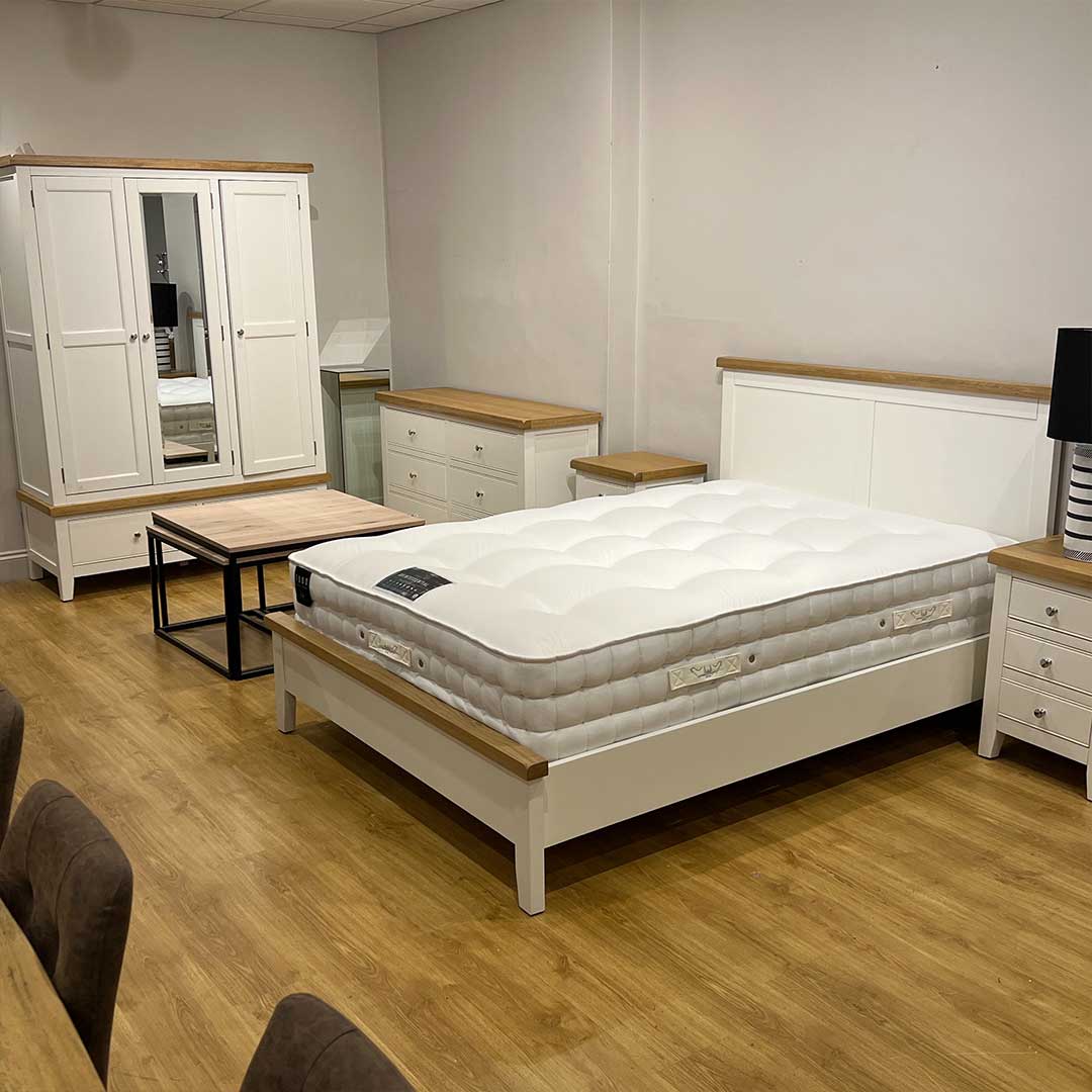 Enfield white painted bedroom range with oak tops. The set includes a triple wardrobe, a king size bedframe, 2 bedsides and a 6 drawer chest of drawers