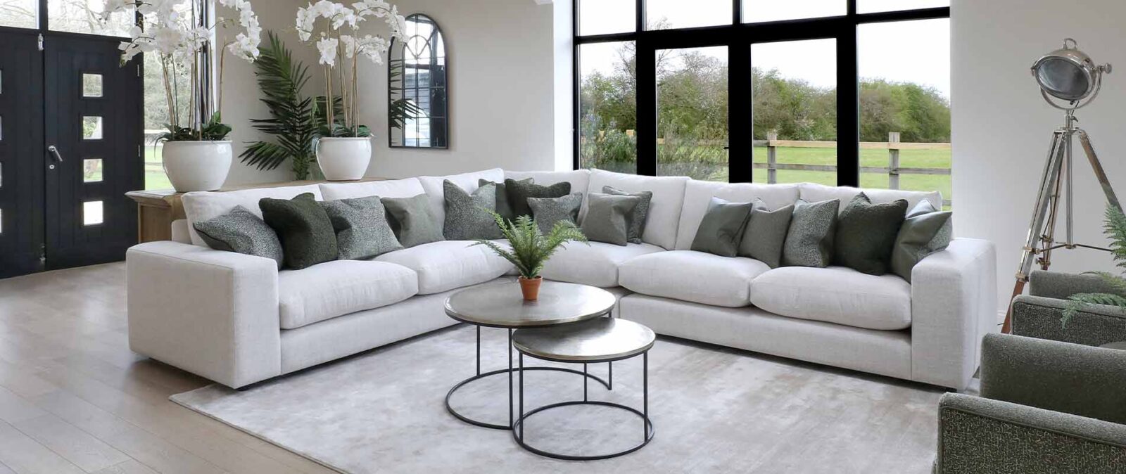 Large white corner sofa in a barn living room.