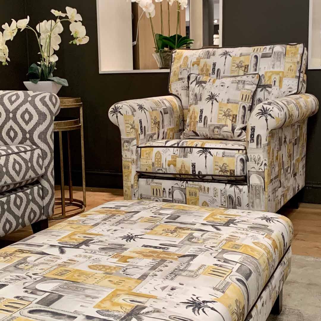 Astor chair and footstool in yellow marakesh fabric by Clarke and Clarke